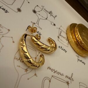 Gold twisted croissant half hoop stud earrings